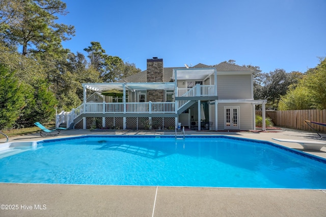 7001 Robert Ruark Dr SE, Southport, NC 28461 - view of swimming pool featuring stairs, french doors, a patio area, a deck, and a diving board