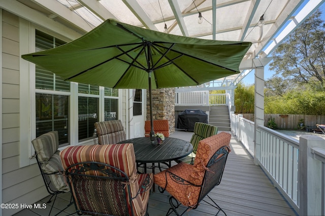 7001 Robert Ruark Dr SE, Southport, NC 28461 - wooden deck with grilling area, outdoor dining space, and stairway