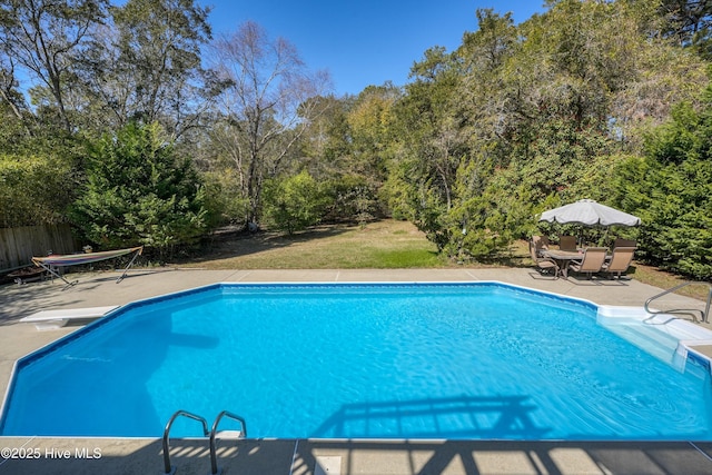 7001 Robert Ruark Dr SE, Southport, NC 28461 - outdoor pool with a patio, a diving board, and outdoor dining area
