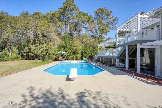 7001 Robert Ruark Dr SE, Southport, NC 28461 - swimming pool featuring a pergola, a diving board, a patio area, and stairs