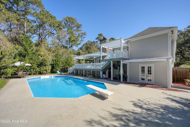 7001 Robert Ruark Dr SE, Southport, NC 28461 - view of swimming pool with stairs, a pergola, a patio area, and french doors