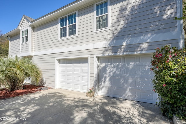 7001 Robert Ruark Dr SE, Southport, NC 28461 - view of side of property with concrete driveway and a garage