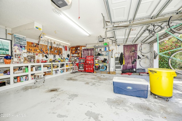 7001 Robert Ruark Dr SE, Southport, NC 28461 - garage featuring a garage door opener and a workshop area
