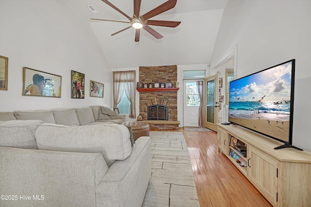 7001 Robert Ruark Dr SE, Southport, NC 28461 - living area featuring high vaulted ceiling, ceiling fan, light wood finished floors, and a fireplace