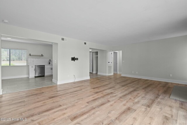 280 Sugar Gum Ln # 165, Pinehurst, NC 28374 - unfurnished living room featuring light wood-type flooring and baseboards