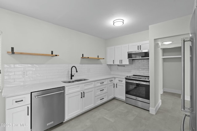 280 Sugar Gum Ln # 165, Pinehurst, NC 28374 - kitchen with appliances with stainless steel finishes, open shelves, a sink, and backsplash