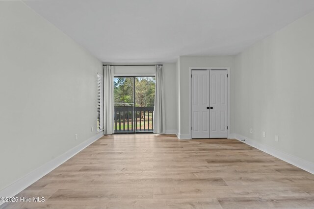 280 Sugar Gum Ln # 165, Pinehurst, NC 28374 - unfurnished bedroom featuring access to outside, light wood finished floors, and baseboards