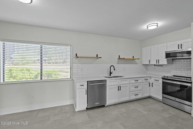 280 Sugar Gum Ln # 165, Pinehurst, NC 28374 - kitchen featuring open shelves, appliances with stainless steel finishes, a sink, decorative backsplash, and light countertops