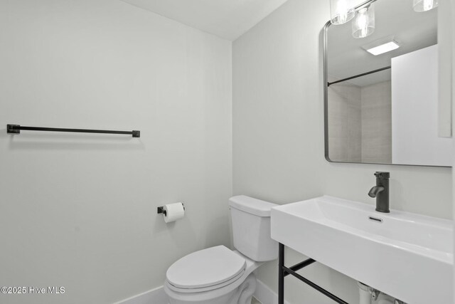 280 Sugar Gum Ln # 165, Pinehurst, NC 28374 - bathroom featuring toilet, a sink, and baseboards