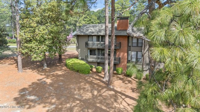 280 Sugar Gum Ln # 165, Pinehurst, NC 28374 - back of property with a balcony, a chimney, and brick siding