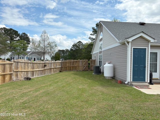 view of yard featuring central air condition unit and fence