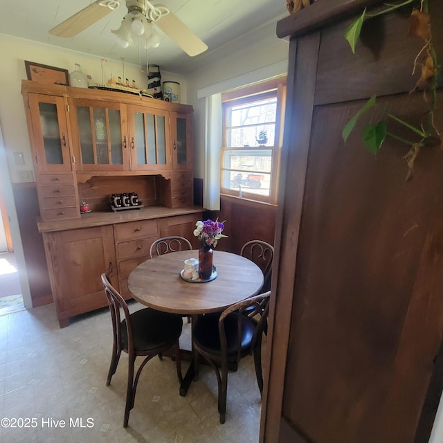 dining space with a ceiling fan and light floors
