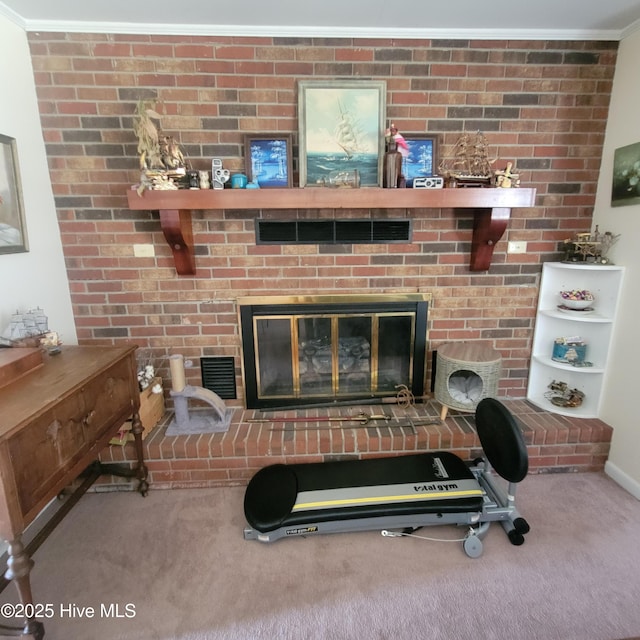 interior details featuring ornamental molding, carpet, a fireplace, and visible vents