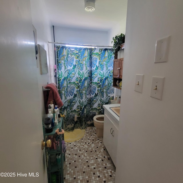 full bath featuring toilet, tile patterned floors, a shower with shower curtain, and vanity