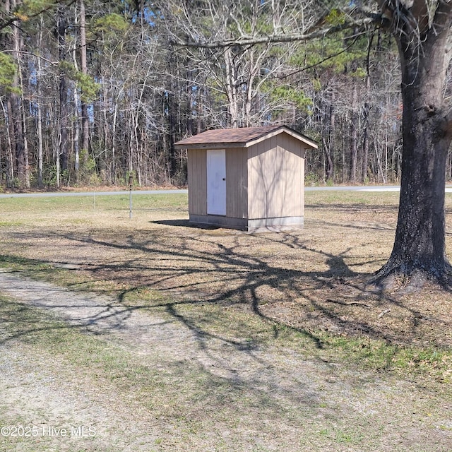 view of shed featuring a forest view