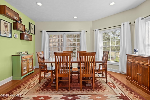 dining room with light wood-style floors, baseboards, and recessed lighting