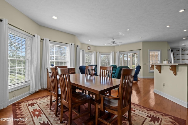 dining room featuring baseboards, recessed lighting, and light wood finished floors