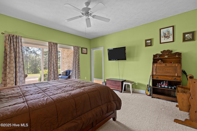 carpeted bedroom featuring baseboards, ceiling fan, and access to exterior
