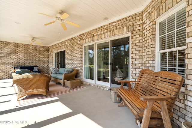 view of patio / terrace with ceiling fan and an outdoor living space