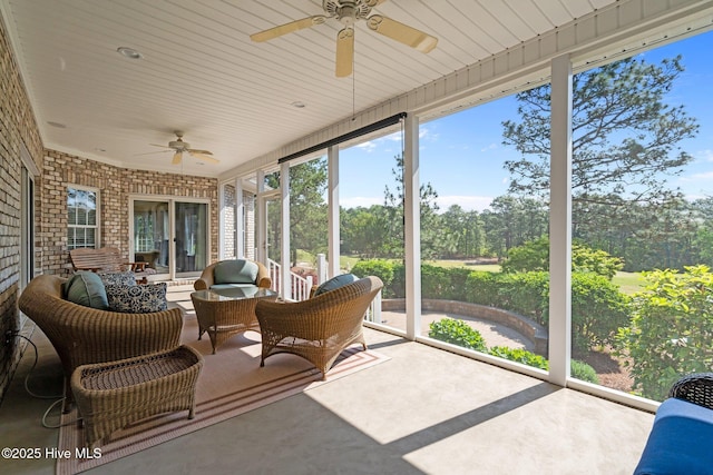 sunroom featuring ceiling fan and outdoor lounge area