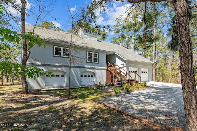 222 Brite Ln, Oriental, NC 28571 - view of front of home featuring stairs, driveway, stucco siding, and an attached garage