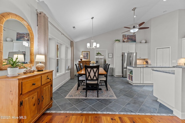 222 Brite Ln, Oriental, NC 28571 - dining room with ceiling fan with notable chandelier, visible vents, high vaulted ceiling, and dark wood-style flooring