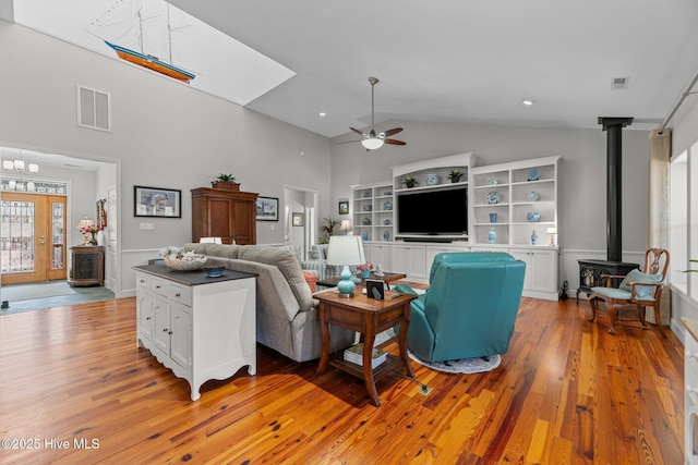 222 Brite Ln, Oriental, NC 28571 - living room featuring light wood finished floors, visible vents, ceiling fan, and a wood stove