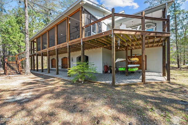 222 Brite Ln, Oriental, NC 28571 - view of side of home with stairs, stucco siding, a sunroom, and a deck