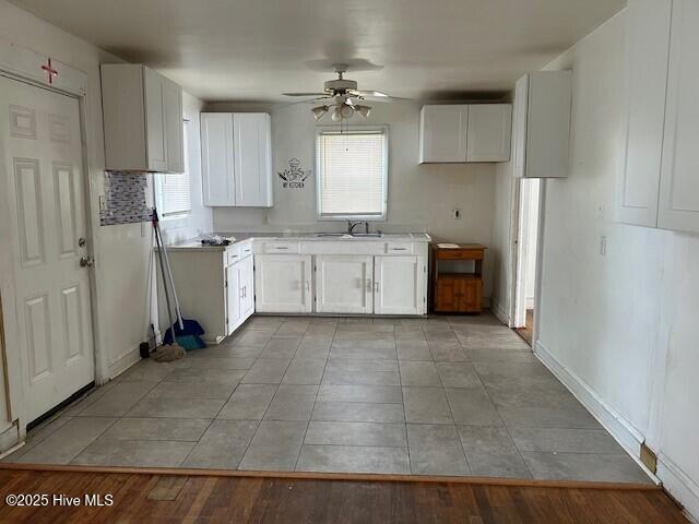 902 Johnston St, Edenton, NC 27932 - kitchen featuring ceiling fan, a sink, white cabinets, and plenty of natural light