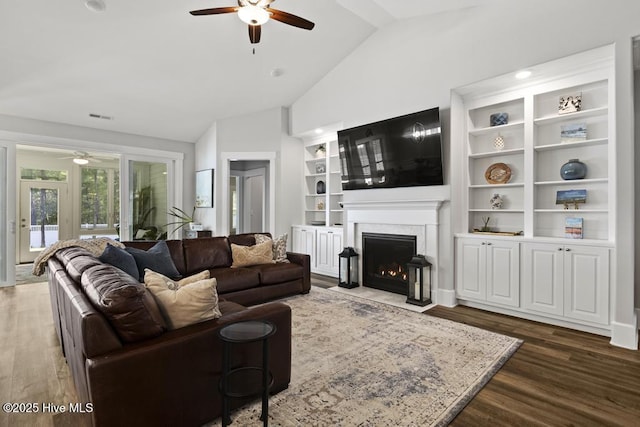 323 Lightning Bug Ln, Holly Ridge, NC 28445 - living area featuring ceiling fan, lofted ceiling, a fireplace with flush hearth, dark wood-style floors, and built in features