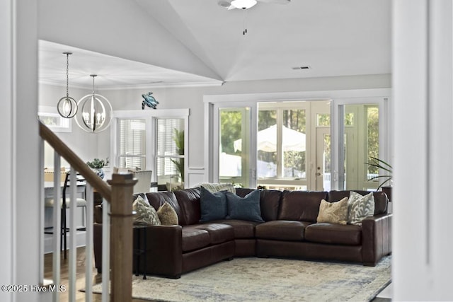 323 Lightning Bug Ln, Holly Ridge, NC 28445 - living room featuring vaulted ceiling, a chandelier, crown molding, a decorative wall, and ceiling fan