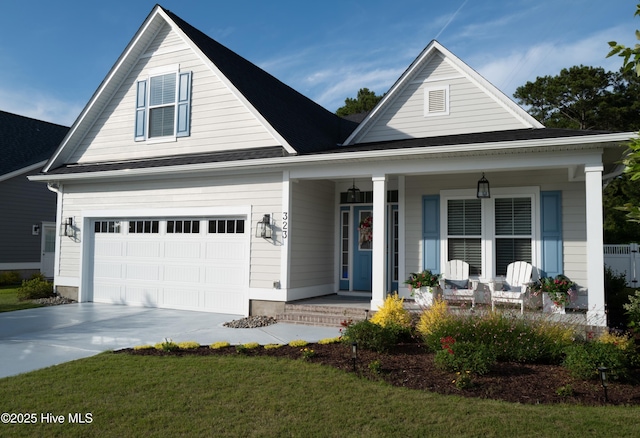 323 Lightning Bug Ln, Holly Ridge, NC 28445 - view of front facade with a porch, driveway, a garage, and a front yard