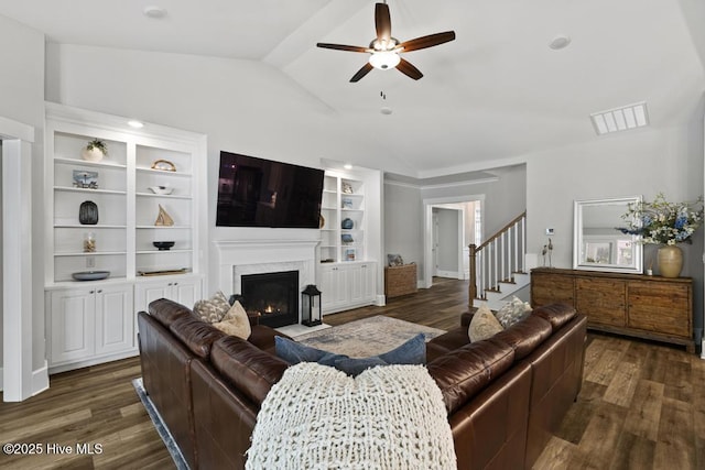 323 Lightning Bug Ln, Holly Ridge, NC 28445 - living area featuring vaulted ceiling, ceiling fan, dark wood finished floors, a fireplace with flush hearth, and built in shelves