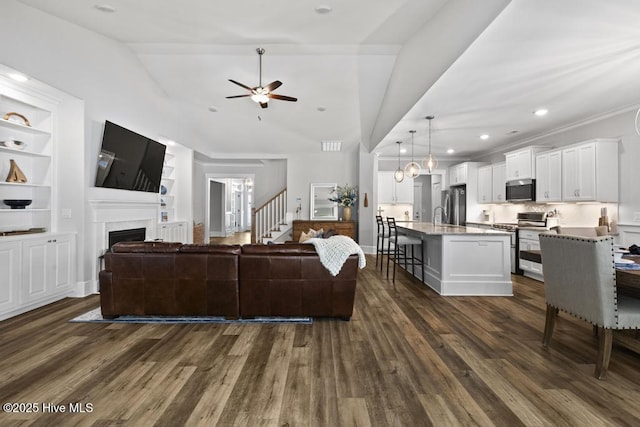 323 Lightning Bug Ln, Holly Ridge, NC 28445 - living area with ceiling fan, vaulted ceiling, dark wood finished floors, a fireplace, and built in features