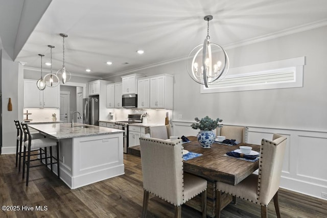 323 Lightning Bug Ln, Holly Ridge, NC 28445 - dining space featuring crown molding, a chandelier, dark wood-style flooring, recessed lighting, and wainscoting