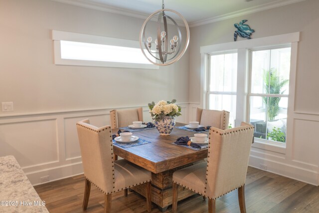 323 Lightning Bug Ln, Holly Ridge, NC 28445 - dining room with a decorative wall, crown molding, a chandelier, healthy amount of natural light, and wood finished floors