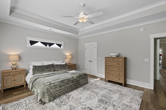 323 Lightning Bug Ln, Holly Ridge, NC 28445 - bedroom with a raised ceiling, crown molding, wood finished floors, a closet, and baseboards