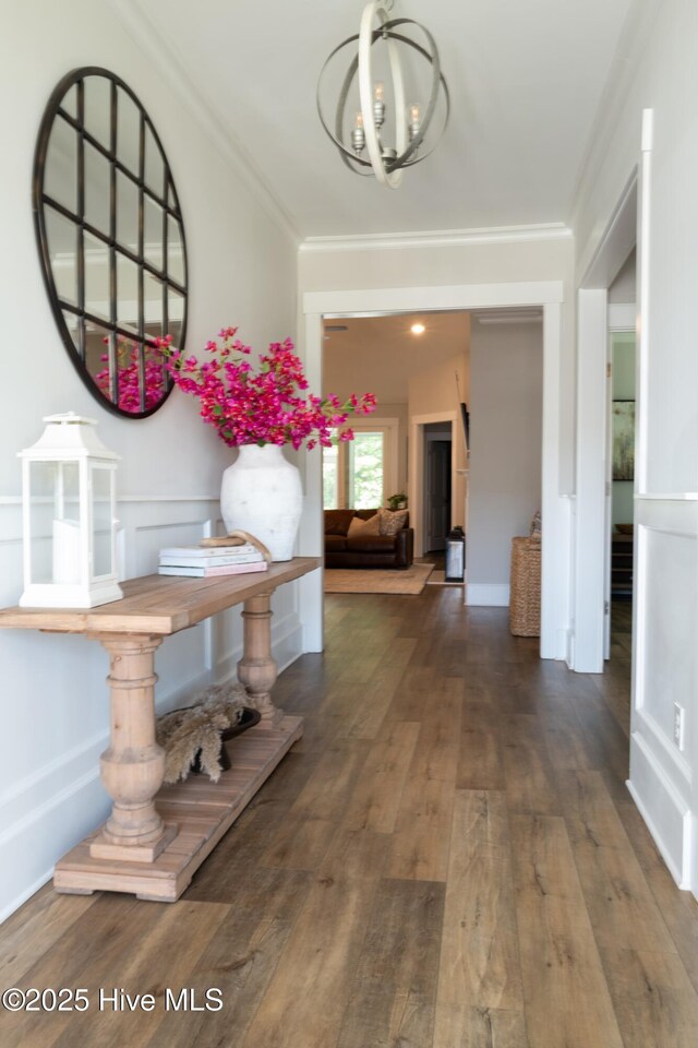 323 Lightning Bug Ln, Holly Ridge, NC 28445 - hall with ornamental molding, hardwood / wood-style floors, and a chandelier
