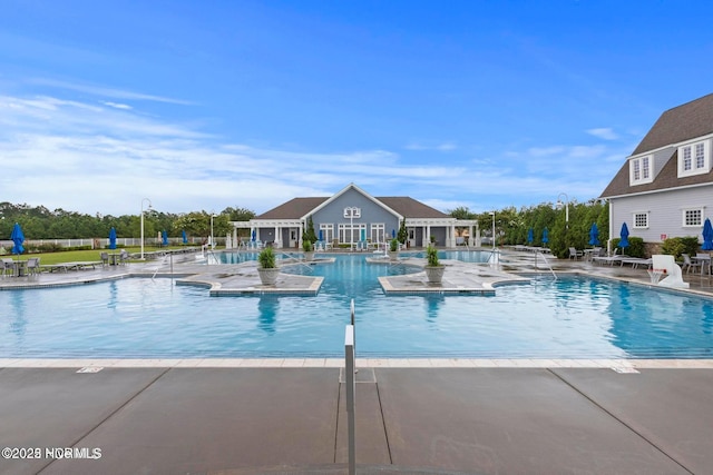 323 Lightning Bug Ln, Holly Ridge, NC 28445 - community pool featuring a patio