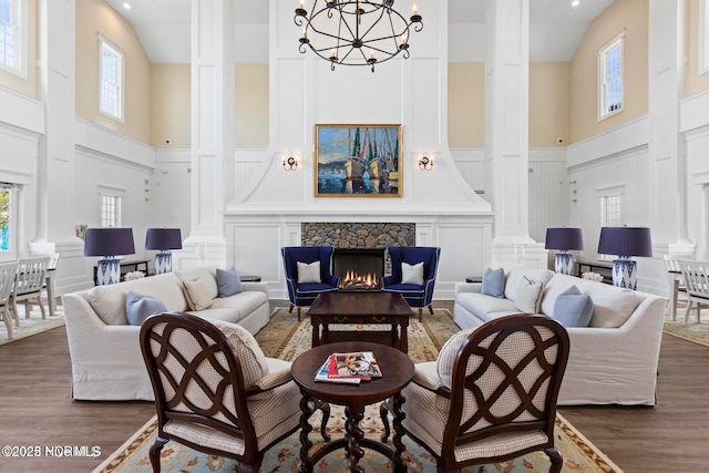 323 Lightning Bug Ln, Holly Ridge, NC 28445 - living area featuring a towering ceiling, a decorative wall, decorative columns, plenty of natural light, and a chandelier