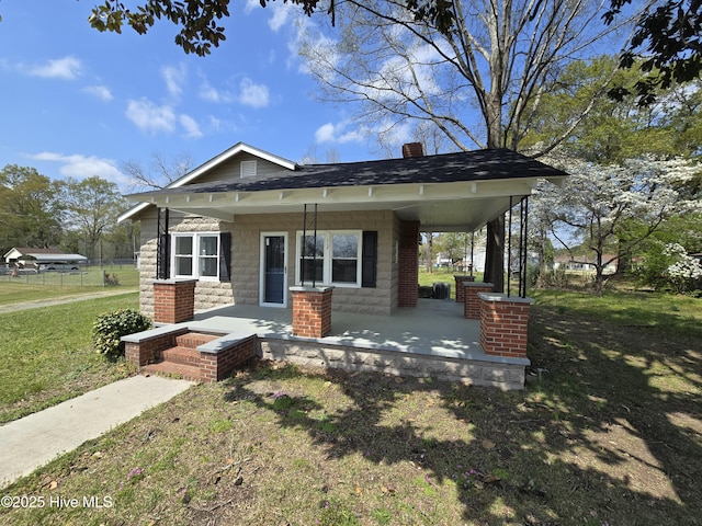 117 Flowers St, Rockingham, NC 28379 - view of front of property featuring a chimney, a porch, and a front lawn
