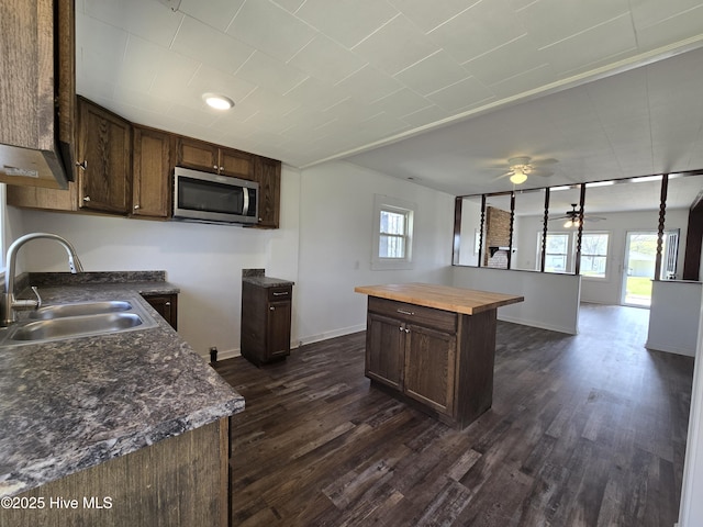 117 Flowers St, Rockingham, NC 28379 - kitchen featuring stainless steel microwave, butcher block counters, a ceiling fan, a sink, and a wealth of natural light