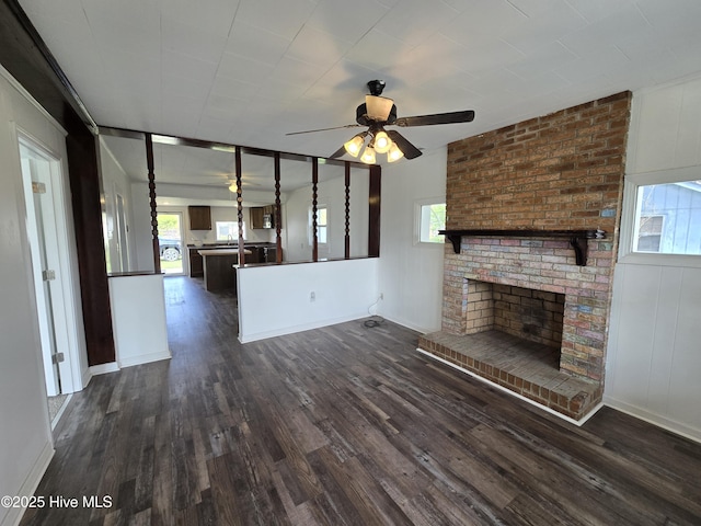 117 Flowers St, Rockingham, NC 28379 - unfurnished living room featuring a ceiling fan, dark wood-style flooring, plenty of natural light, and a fireplace