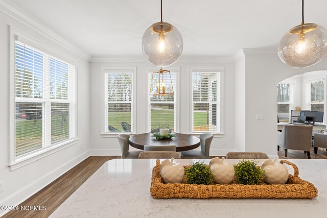 dining room featuring dark wood finished floors, baseboards, arched walkways, and ornamental molding