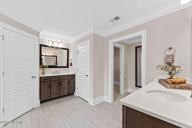 full bathroom with baseboards, visible vents, a sink, and two vanities