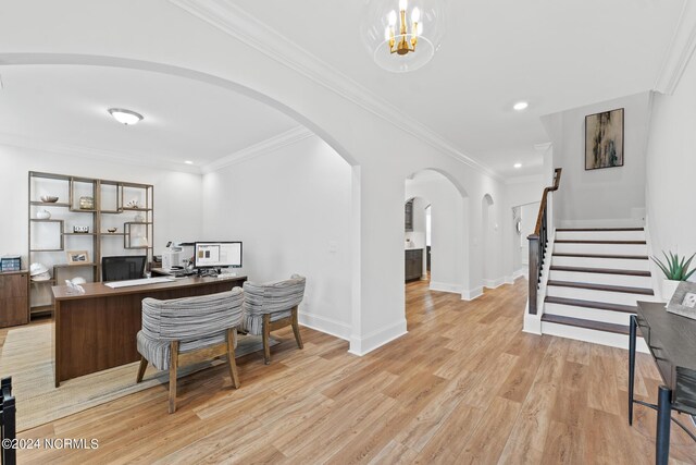 office featuring arched walkways, ornamental molding, baseboards, and light wood-style floors