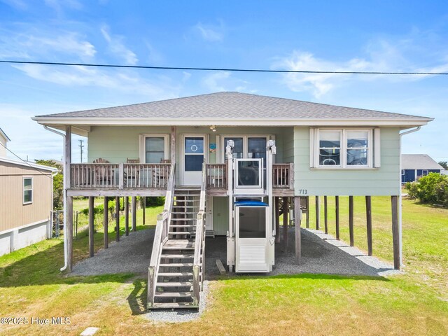 713 Channel Blvd, Topsail Beach, NC 28445 - view of play area with a lawn, a porch, and stairway