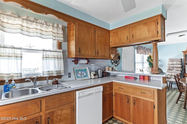 713 Channel Blvd, Topsail Beach, NC 28445 - kitchen featuring white dishwasher, brown cabinetry, a peninsula, and a sink