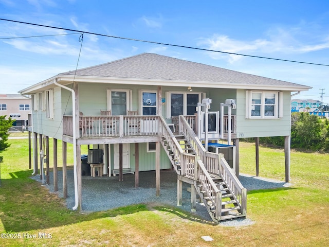 713 Channel Blvd, Topsail Beach, NC 28445 - rear view of property featuring covered porch, a shingled roof, a lawn, stairway, and a carport