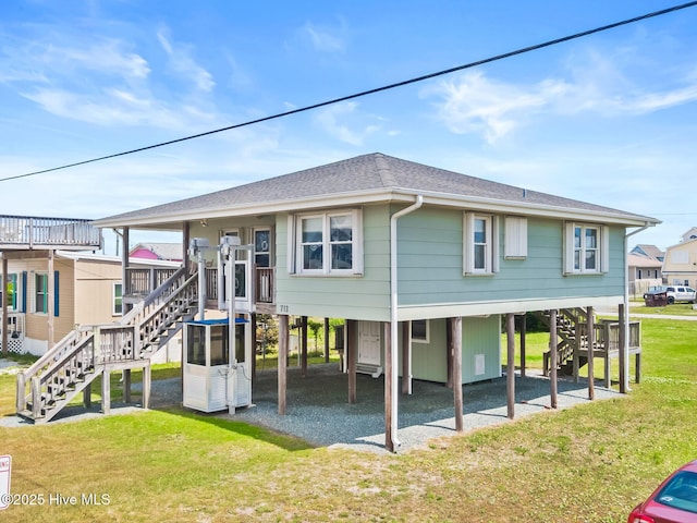 713 Channel Blvd, Topsail Beach, NC 28445 - back of house featuring stairs, a shingled roof, a carport, a yard, and driveway